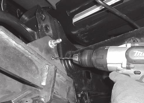 Repeat this process on the driver's side, noting that the rearmost cap screw on handle must be inserted through the round hole behind the rear bracket as shown.