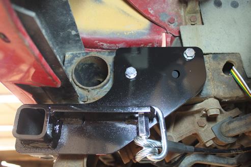 1. Using a 16MM socket, remove the two (2) existing frame bolts. Position the baseplate onto the vehicle. Install the 7/16-14 x 6 bolts with lock washers into the existing frame holes.
