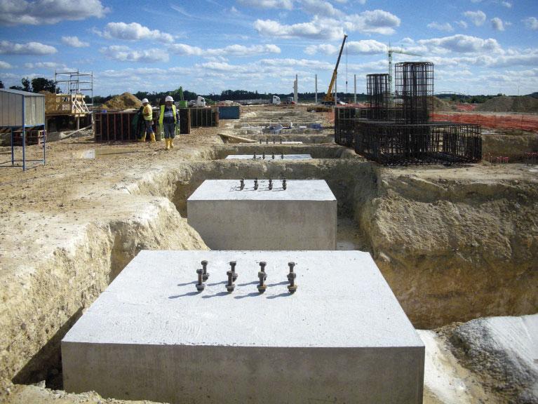 The anchors are embedded into concrete and the structures are fastened to bolts by nuts and washers.