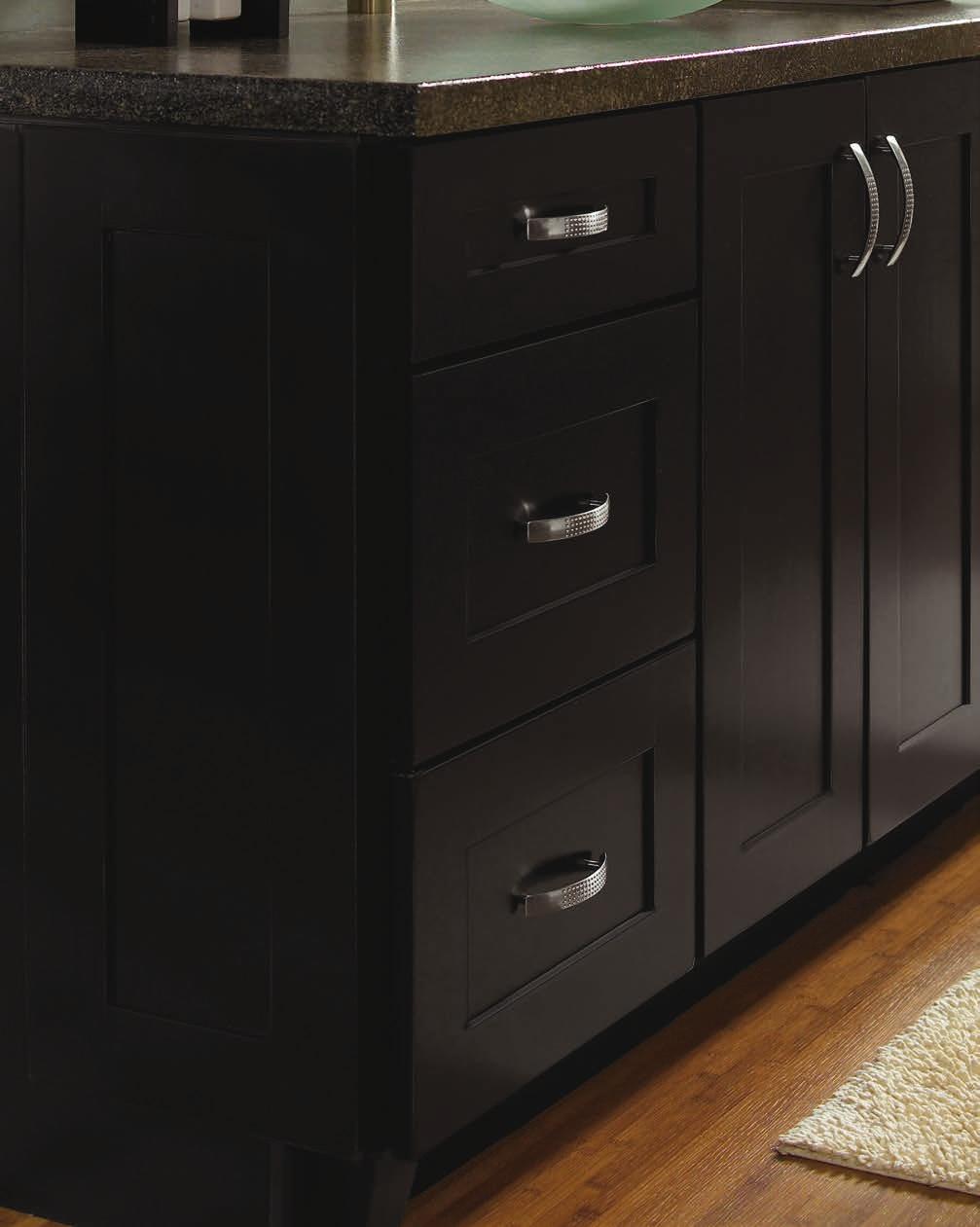 Cabinetry features doors with reverse raised center panels and solid slab drawer fronts.