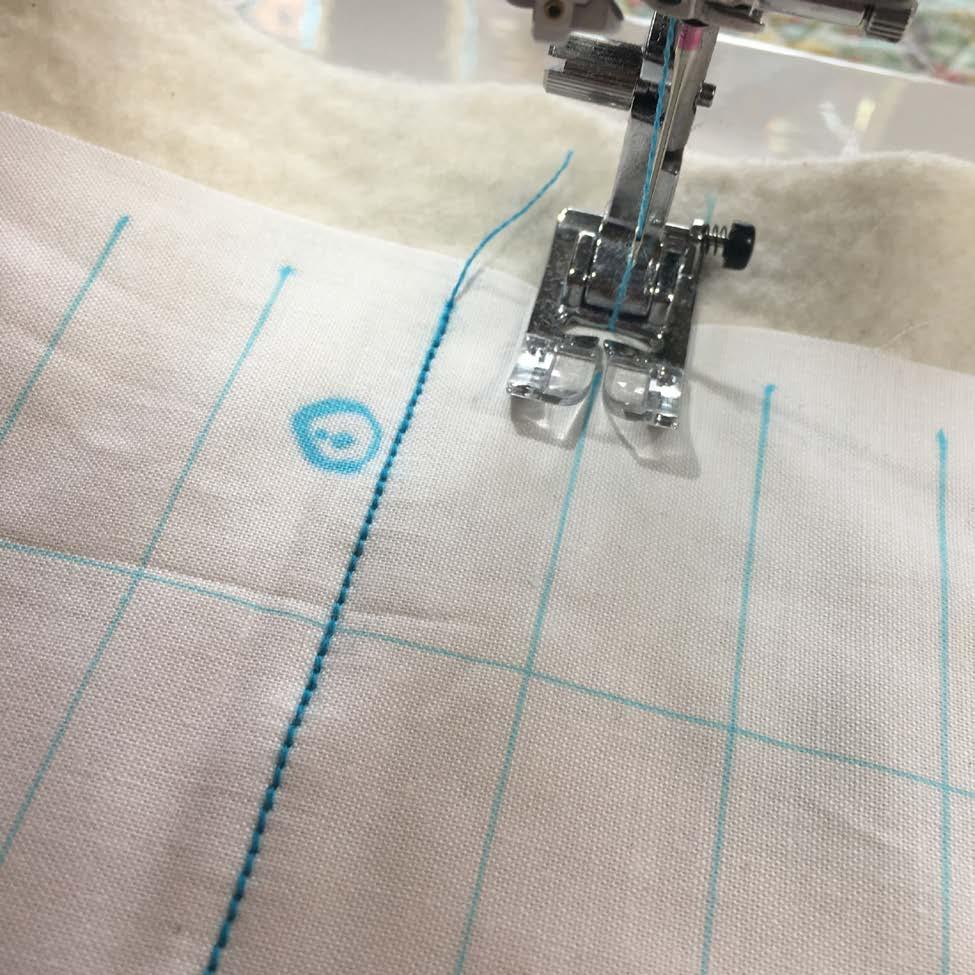 Start by marking your corners about a half inch in (this is about where your binding will be sewn and gives you a guide on how to center and mark your paper lines).