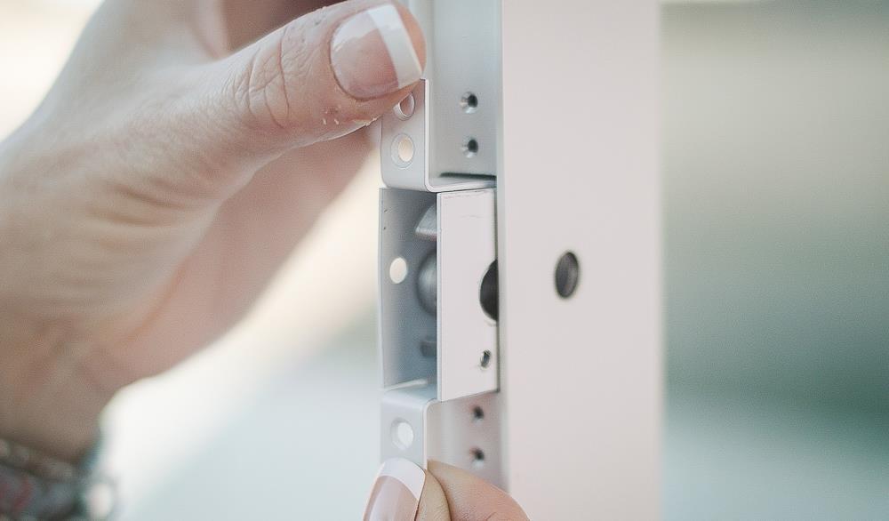 STEP 19: Insert the Door Lock Housing Insert Door Lock Housing on the open side of the assembled pet door panel so that the Lock Arm is in the up position when open as shown in