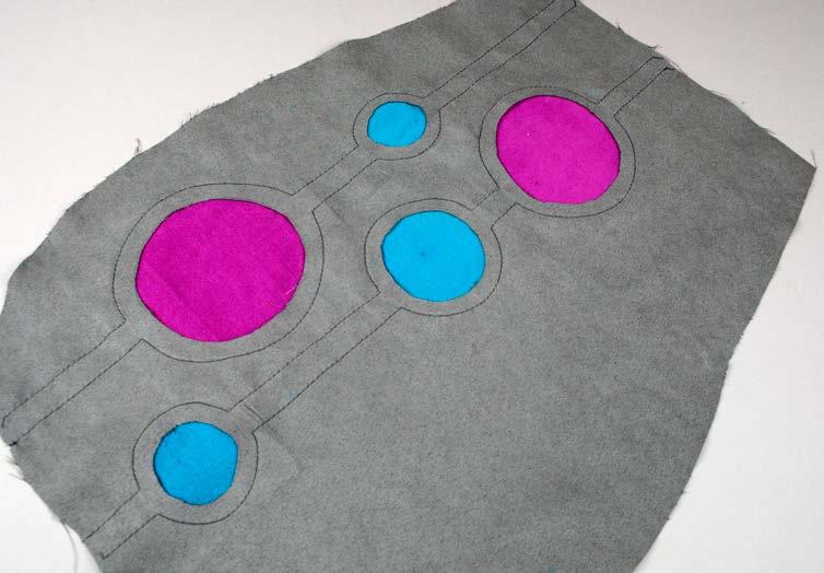 5 Cut out the circles following the cutting guidelines inside the stitching to reveal the accent fabric underneath.