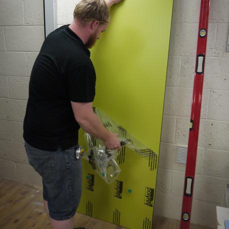 We are now ready to install the cubicle door. Again remove any and all protective material.