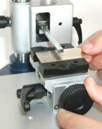 With the other hand, push the module down to approximately 5 mm above clamping device.