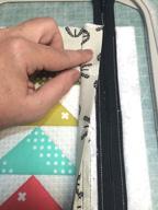 Tape the piece in place, so that the fold stays just below the zipper teeth.
