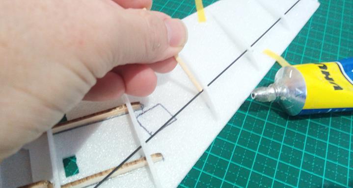 the balsa. Tape one side of the wing to a flat surface before gluing the carbon rod in place.