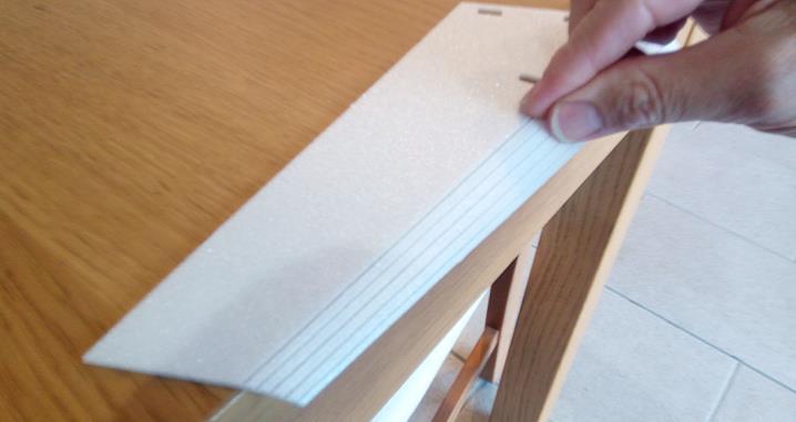 Place the wing upper surface pieces on the edge of a sharp corner such as the edge of a table. Press along each half cut to bend the foam to about 45 degrees.