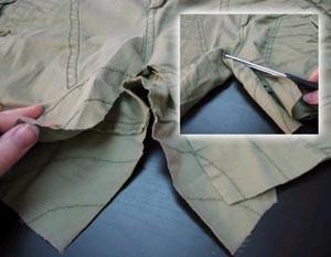 Begin by snipping out the inside seam of the pants.