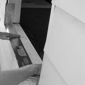 If existing rough sill is not protected with weather barrier self-adhering tape, cut a piece wide enough to lap horizontal run of existing weather barrier (below the rough sill) and provide enough