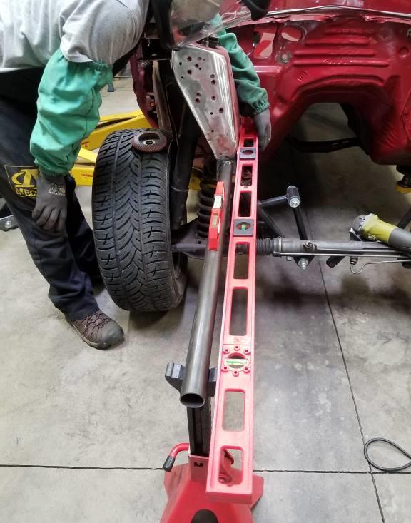 Using a jack-stand, place each frame bar assembly into position. If you choose to not cut back the formed frame on the car, you will need to find a means of holding the frame plate in position.