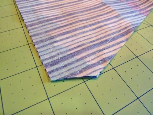 Using a ½" seam allowance, stitch along each long side and across the angled end,