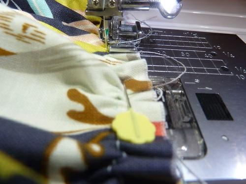 11. Using a ½" seam allowance and a Zipper foot, stitch all the way across, running your seam just below the piping. 12.