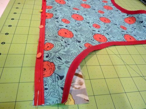 Fold bib B out of the way and pin one length of piping