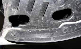 3 3. Just forward of the front tire, on the edge of the fascia, remove two push pins, as