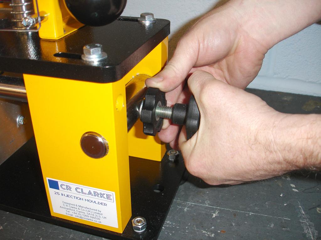 The mould clamp can be adjusted for different sizes of mould using the hand wheels on the right of the machine.