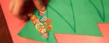 Sticker Garlands green paper marker stickers Cut a tree out of green paper. Draw lines as garland on the tree.