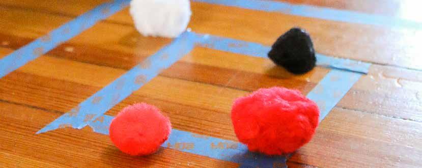 Pom Pom Target painter s tape pom poms or cotton balls straws With painter s tape, tape two squares on the floor, one inside the