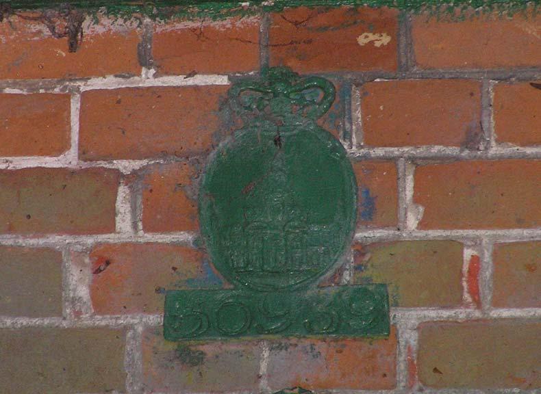 Fig. 6. Fire insurance plaque and detail of brick work. There are chimney stacks to the gable ends with unmemorable chimney pieces.