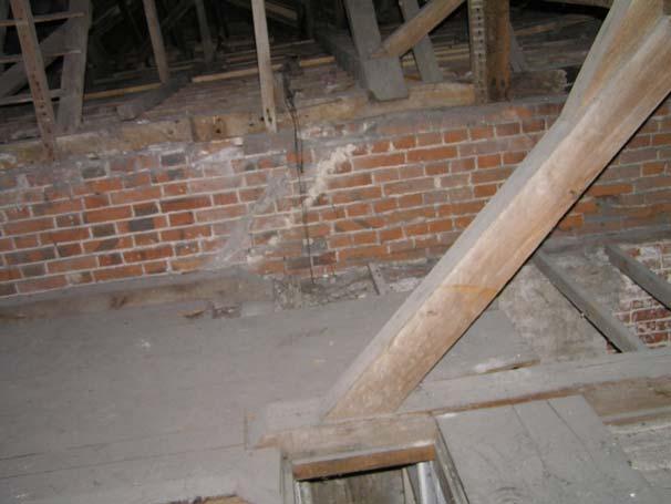 There is provision for the original roof connecting to that of the added cross wing in the form of interrupted tiling battens and shortened rafters.