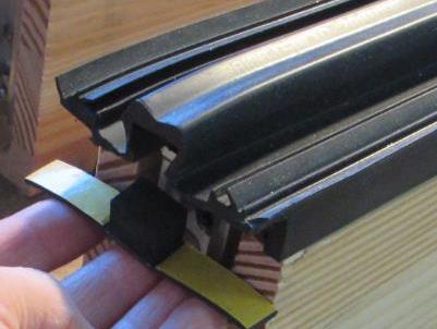 Place the glass panel onto the bottom transom shims, and ensure the glass is seated against the rubber gaskets.