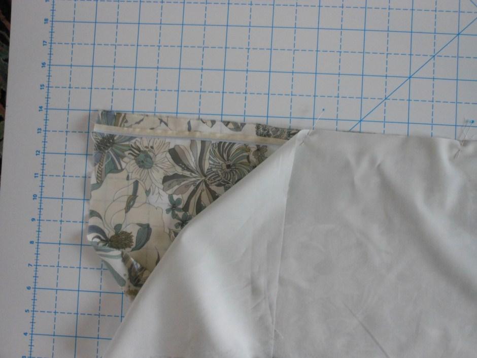 Attach the piping and the band: 1. Attach the piping: Sew the piping to the RIGHT side of the pillowcase, along the side that remains open.