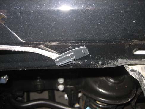 screwdriver to remove four plastic fasteners.