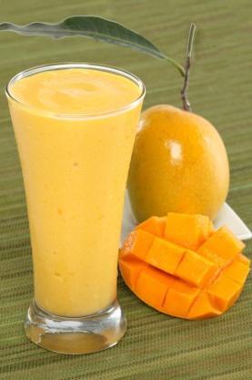 and chop mangoes into small pieces. Transfer them to a blender jar. Add milk, sugar and ice cubes.