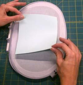 Hoop parchment paper up-side down and trim all excess from edges. See Photos 2 and 3 9.