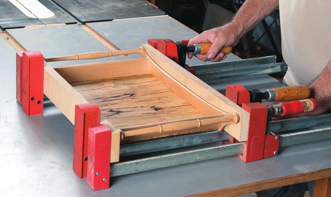 Begin by installing the bottom into one tray side groove, and then extend the groove location toward the end of the side as shown. Repeat at all four corners.