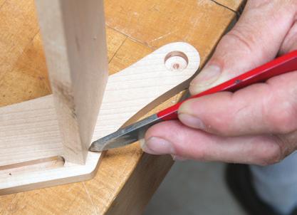 With a tenon in its mortise, carry the groove extension lines from the sides onto both faces of the ends to mark the part to final width. Mark the bottom to width.