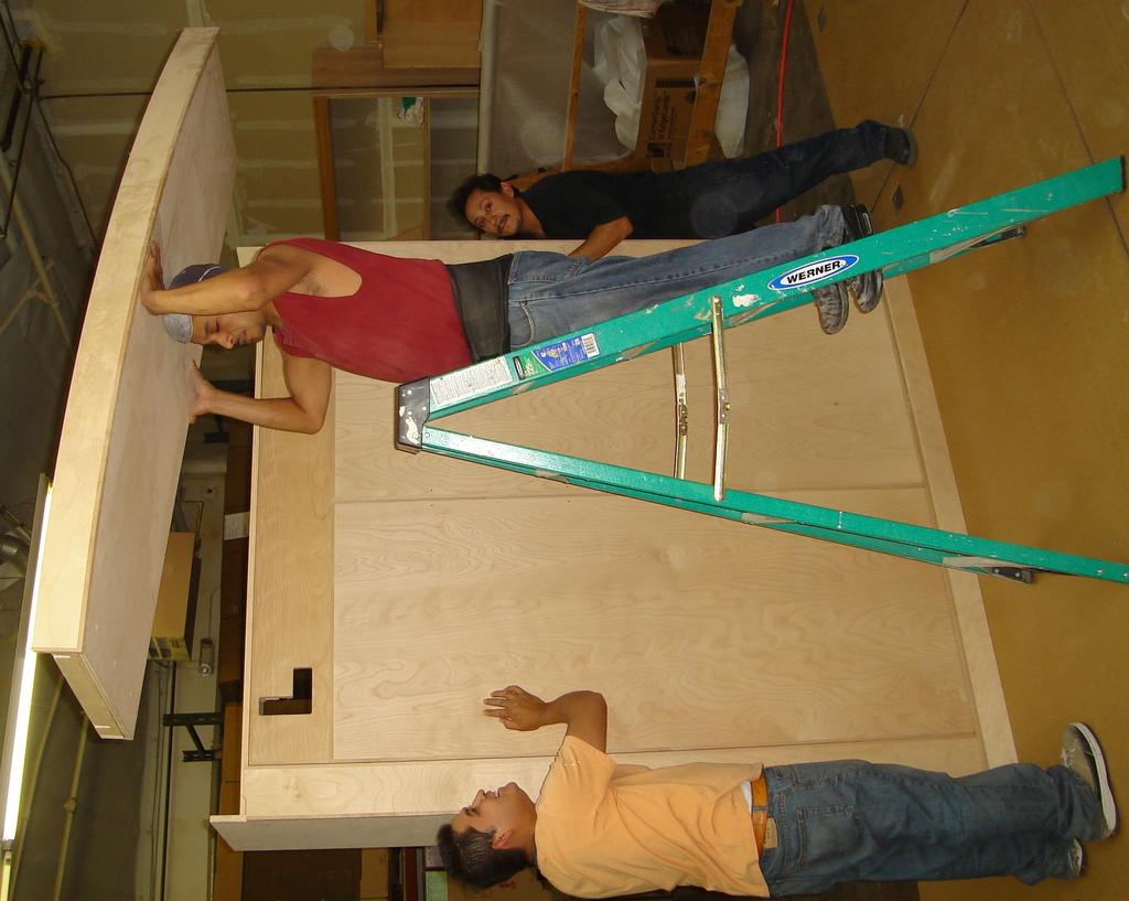 #12 MOUNTING TOP CURVED ASSEMBLY Have at least one person hold the wallbed while you remove the temporary top assembling lifting board (installed in step #10) and replace it with the top curved