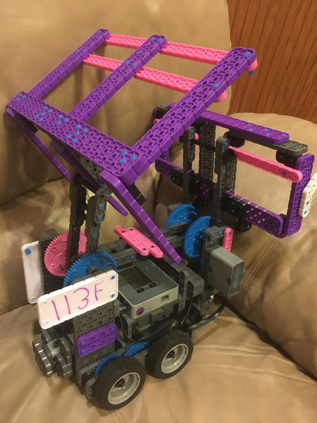 Design 2 We finally decided on our design. We wanted to keep the scoop and basket idea. We thought it needed a little bit of color. We ordered pink and purple VEX parts.