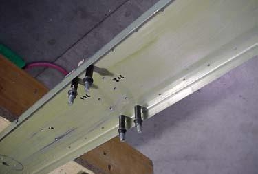 are visible through the pre-drilled holes in the spar) Adjust the