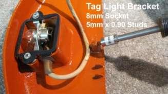 Add a drop of oil on the three tag light assembly studs and run the