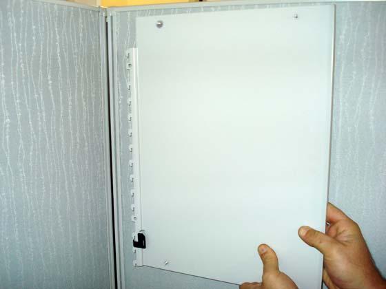 Insert right hand shelf end into right hand hanger frame slightly below the level of a panel topcap.