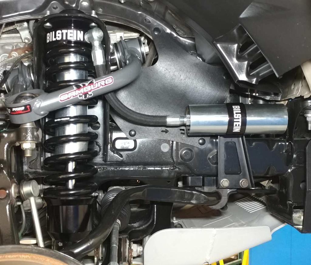 Final right front (passenger) B8 8112 shock installed on vehicle: Aftermarket upper control arm is pictured.