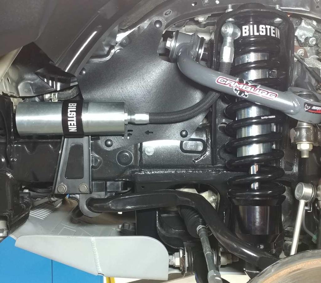 Final left front (driver) B8 8112 shock installed on vehicle: Aftermarket upper control arm is pictured.