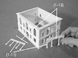 Next, build up the entrance ways of the front and side walls. On the front wall, glue one part (1-11) over top of part (1-8) keeping it centered around the doorway. Repeat on the alley side.