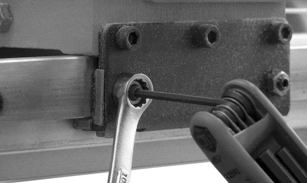 Lay the two mounting brackets (18) on the lathe bed with the offset end of the plate facing down and toward the front side of the lathe (Figure 1).