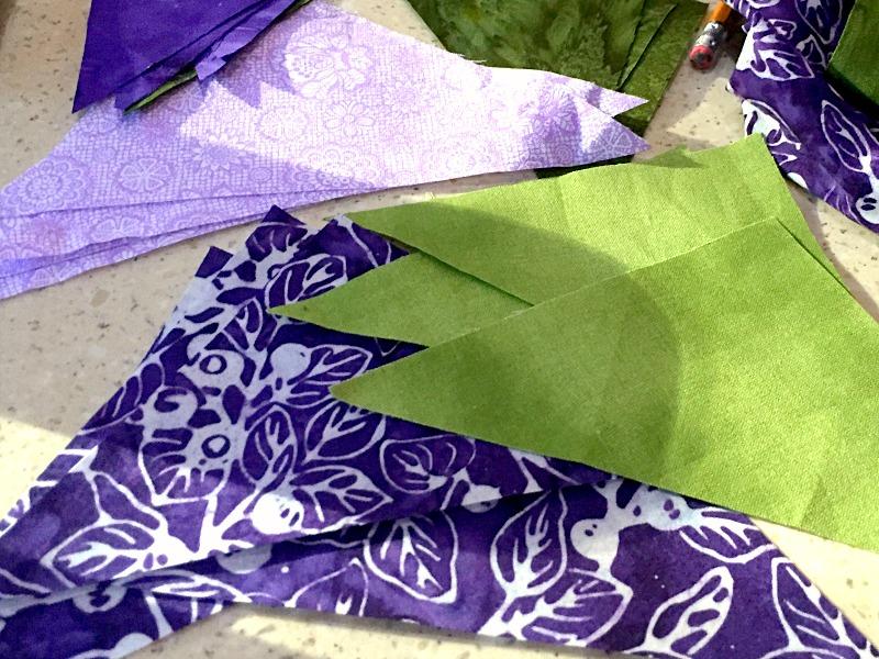 Thinking of Spring Table Topper Table Topper Finished Size: 16" x 16" You will need: 1/4 yard dark purple 1/4 yard dark green 1/4 yard medium purple 1/4 yard fabric of your choice for binding Cut the
