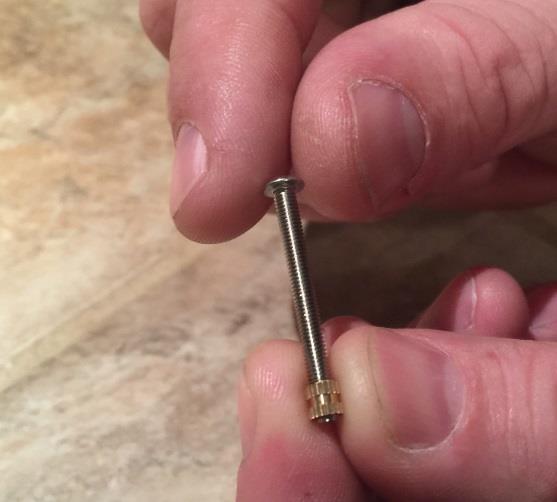 screw through the knurl nut as shown.