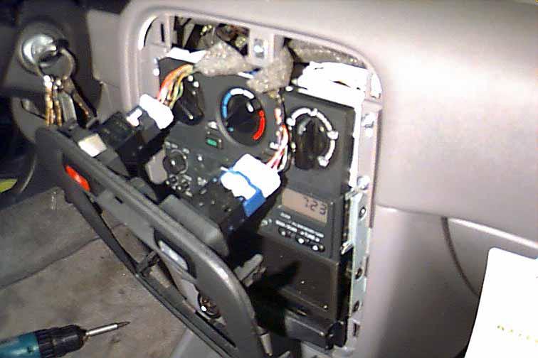 STEP 5: Once the plastic dash panel has been pulled off, the screws securing each side of the radio should be visible.