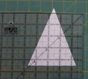 Align the bottom of the triangle with the 4 1/2" line so the tip of the triangle extends past the ruler and cut the tip off.