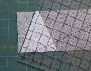 Place the ruler with your template on the fabric so the base of the triangle is aligned with the bottom edge of the fabric.