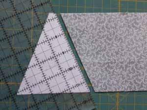 Switch to the opposite side of the ruler and align the bottom edge of the template with the bottom of the fabric.