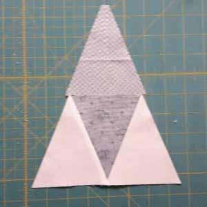Place the triangle onto the already pieced triangles so that