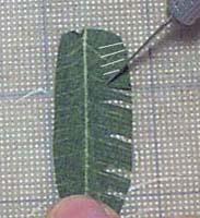 Using a hobby knife, cut a series of slits in the direction shown.