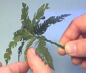 Make one of the leaf wires extra long. Gather the leaves together in a bunch.