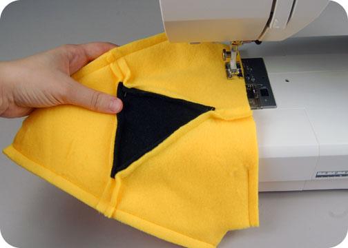 Try to stop exactly on the same point as where the previous seam begins, and no further. This will make your triangle look the cleanest when the project is finished.